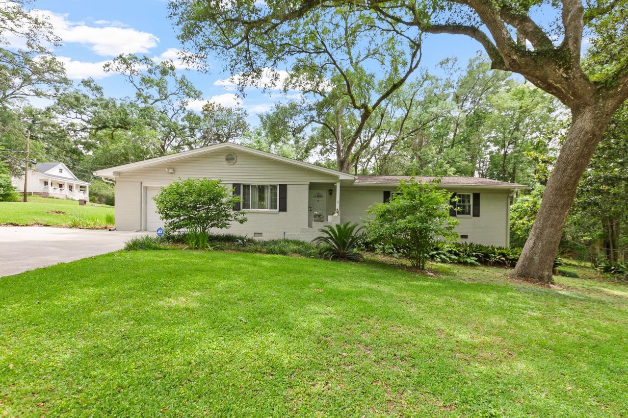 A charming home featuring a welcoming front porch and steps leading to the entrance.