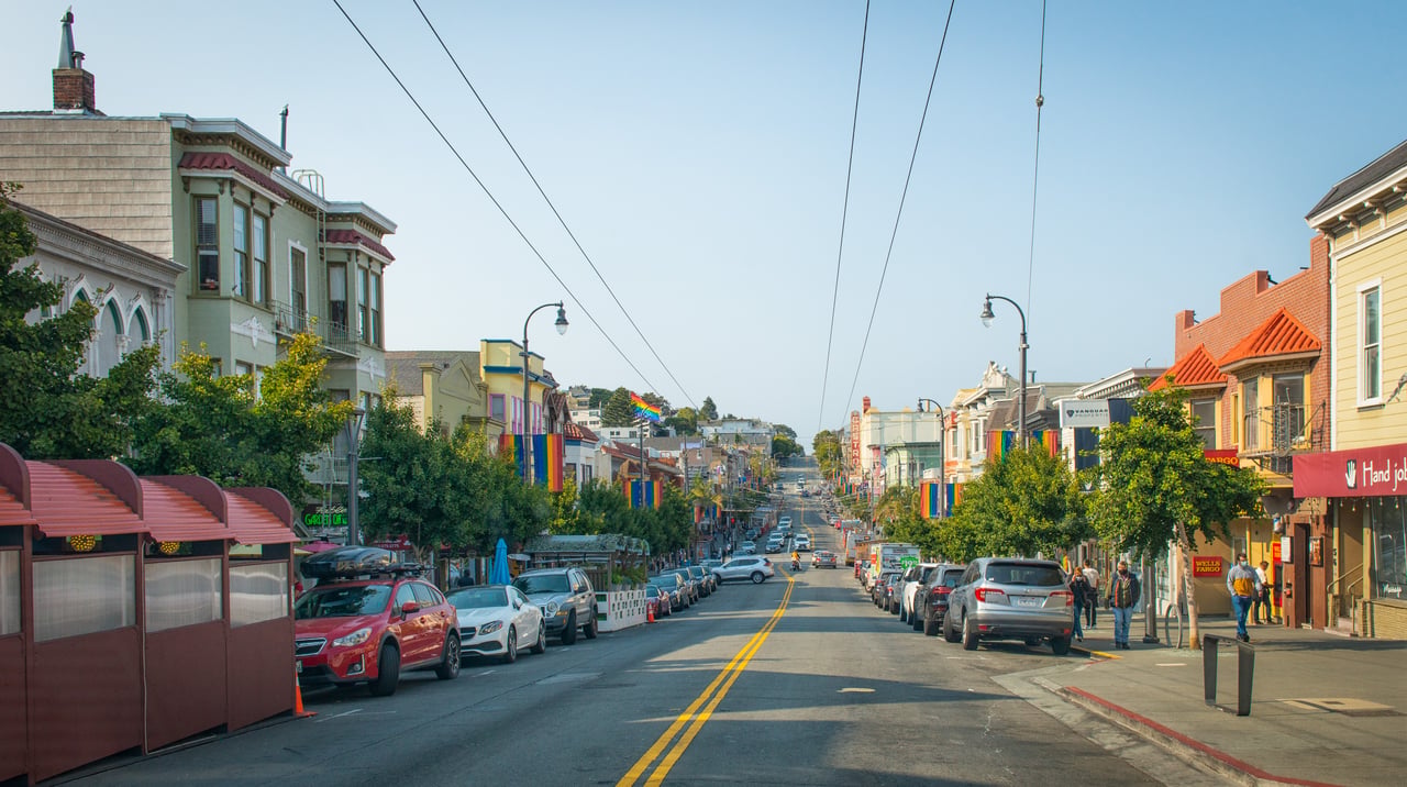 Castro Street in San Francisco with colorful storefronts and rainbow flags