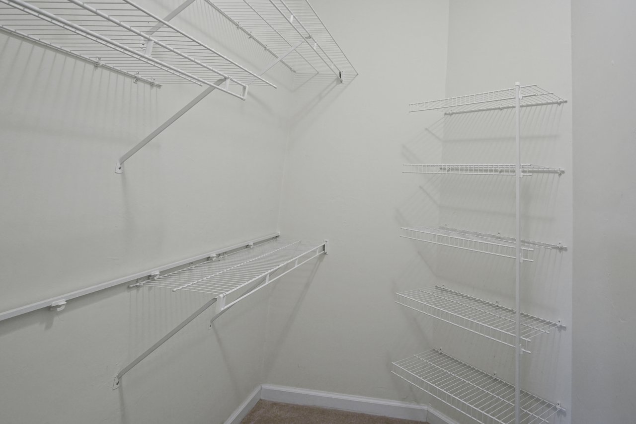 Walk-in closet at 5441 Hampton Hill Circle, Tallahassee, Florida 32311 featuring white wire shelving and neutral walls.