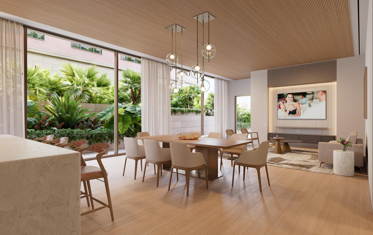 Dining area with globe pendant lights and large windows overlooking tropical landscaping.