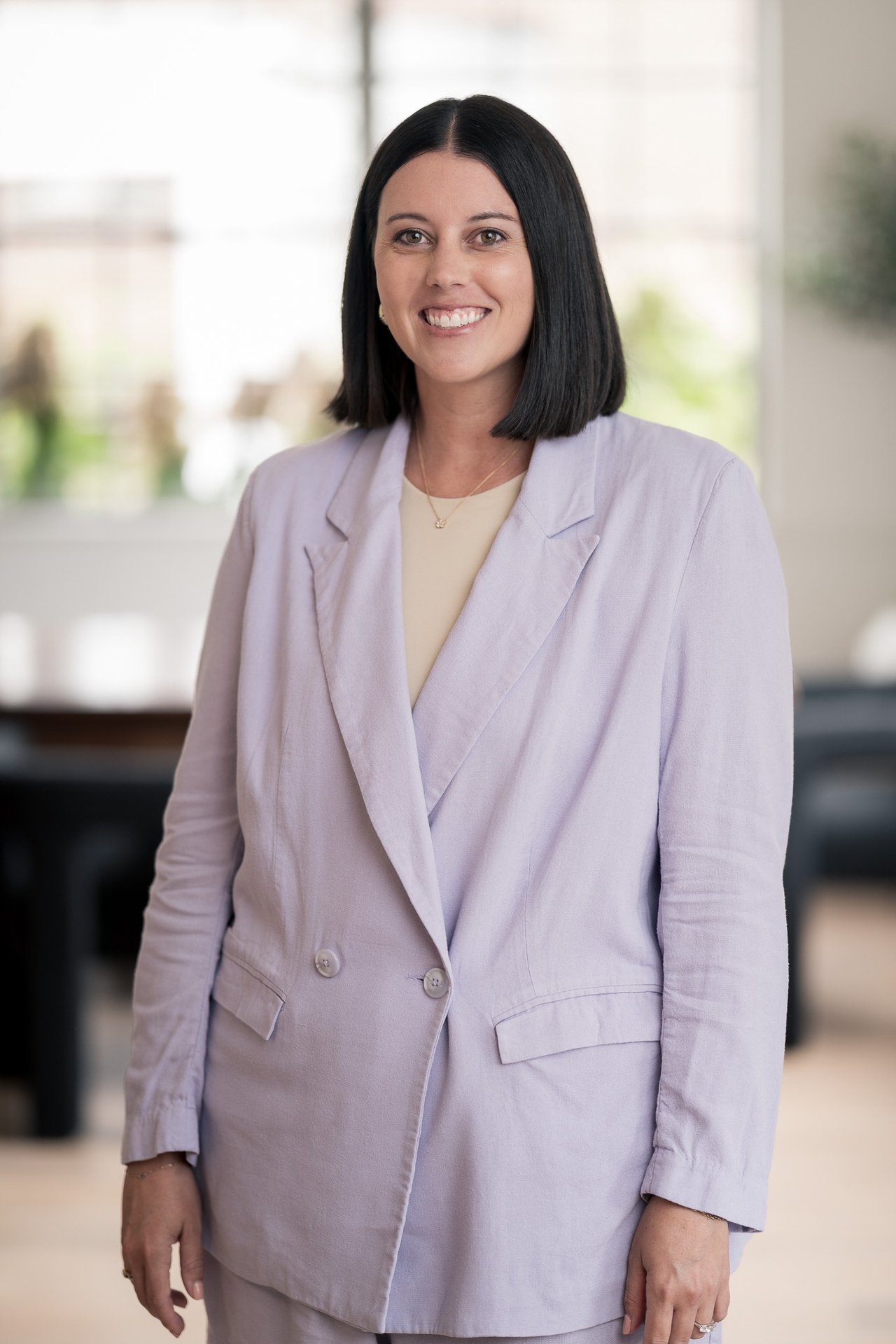 Laurel Poplin smiling in a lavender blazer