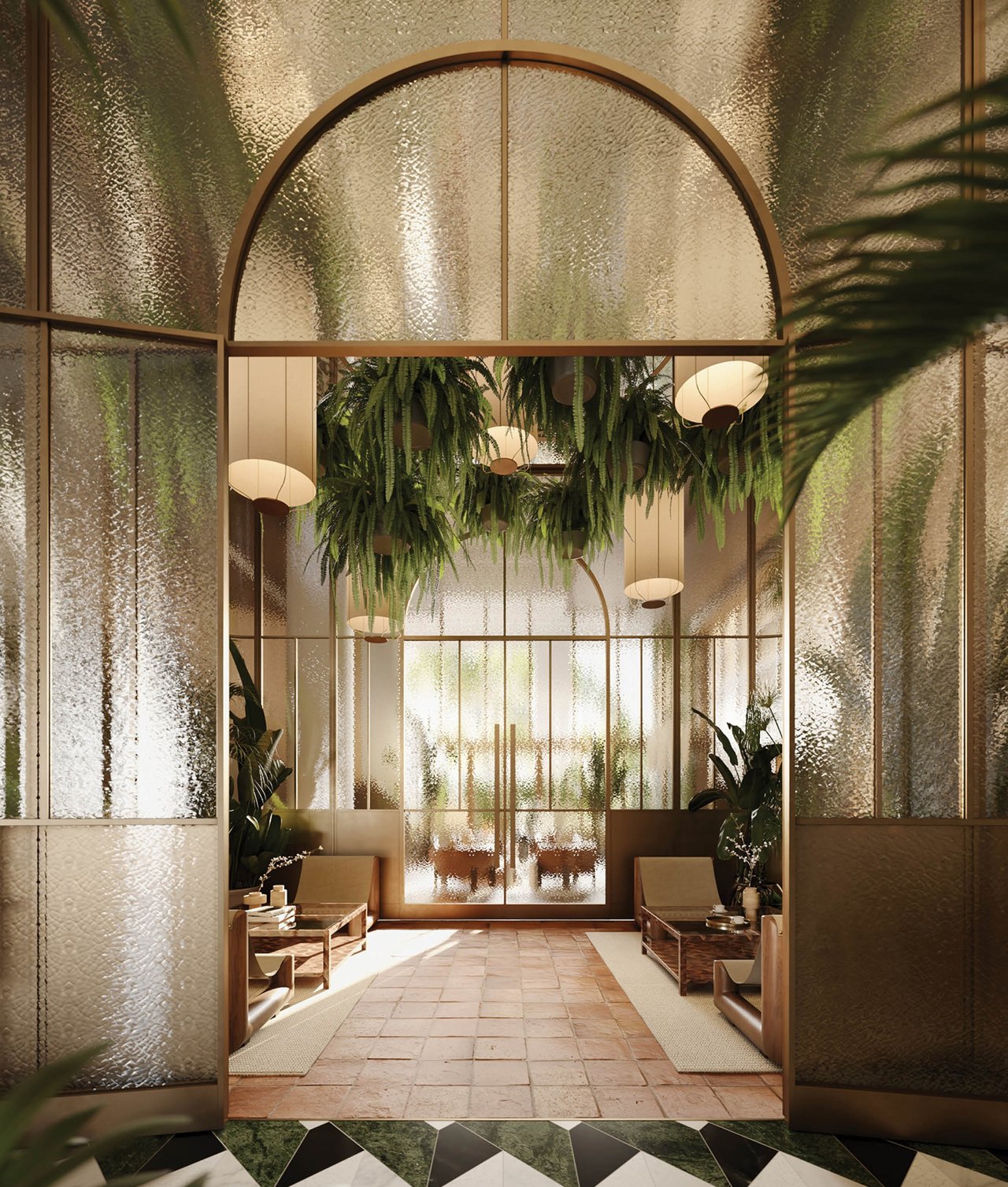 The Well lobby with an arched glass entry, hanging ferns, warm pendant lights, and lounge seating.