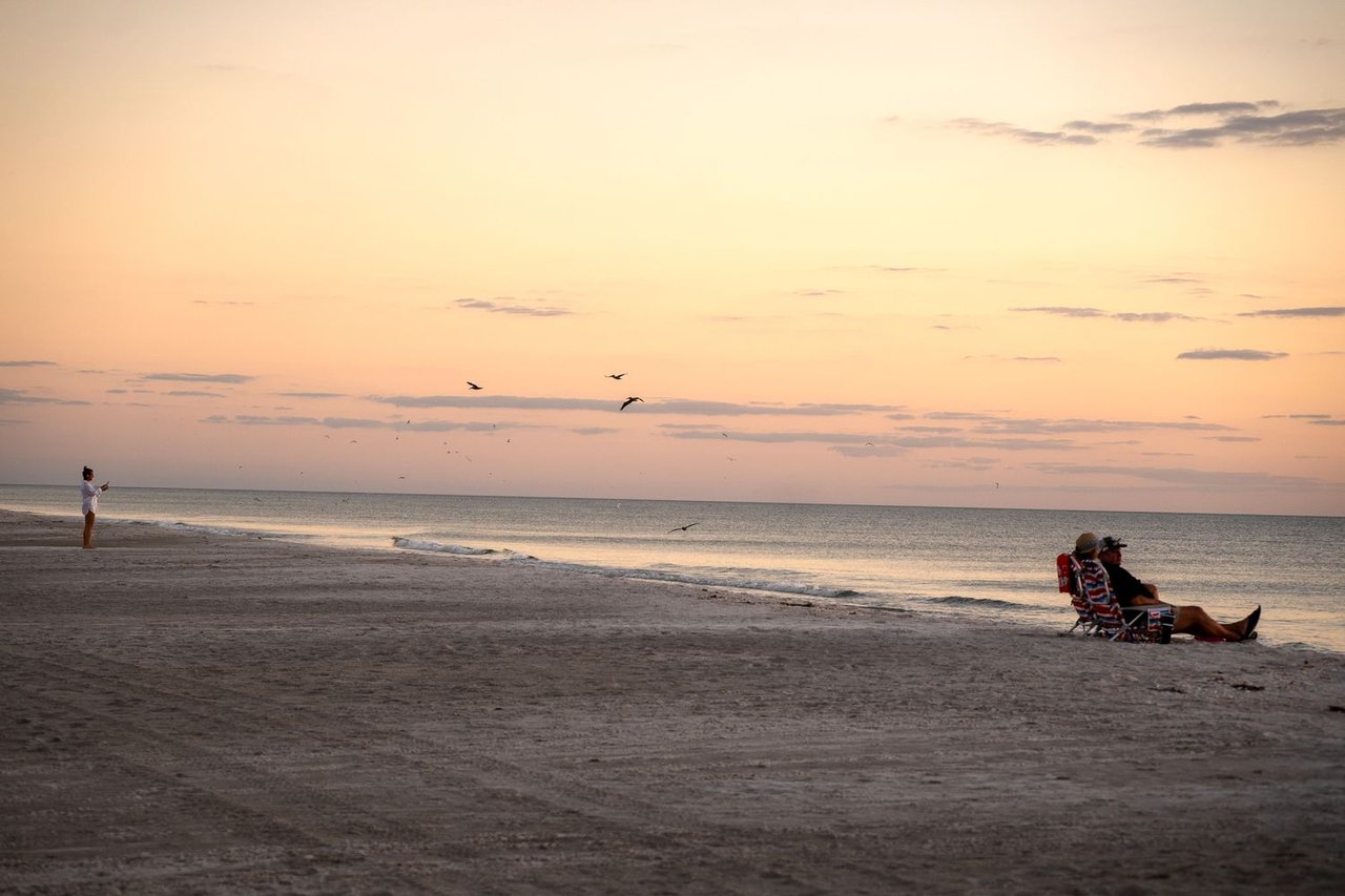 A military from Eglin AFB on the emerald coast sitting on the beach watching the sunset