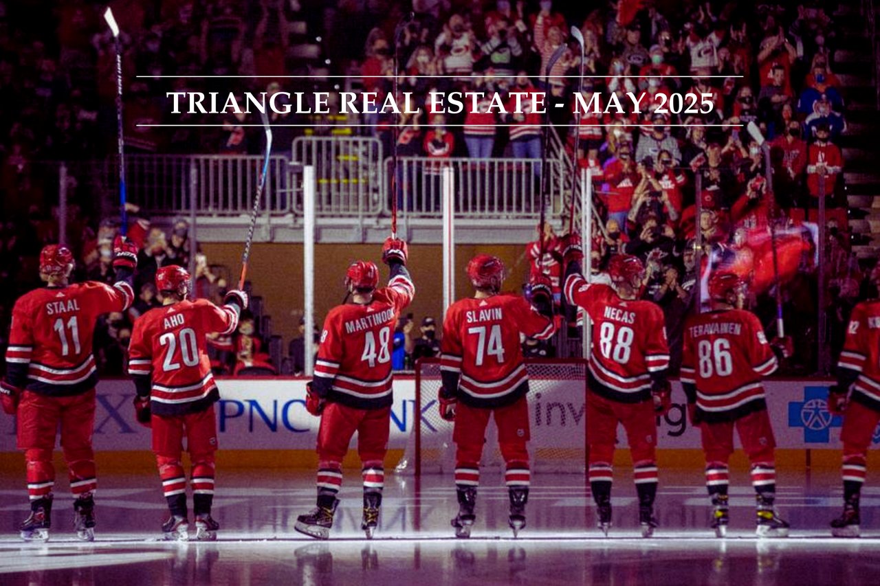 Photo of six Carolina Hurricanes players holding up their sticks after winning a game at Lenovo Center used for The Results Team's Triangle Real Estate May Newsletter Cover Image