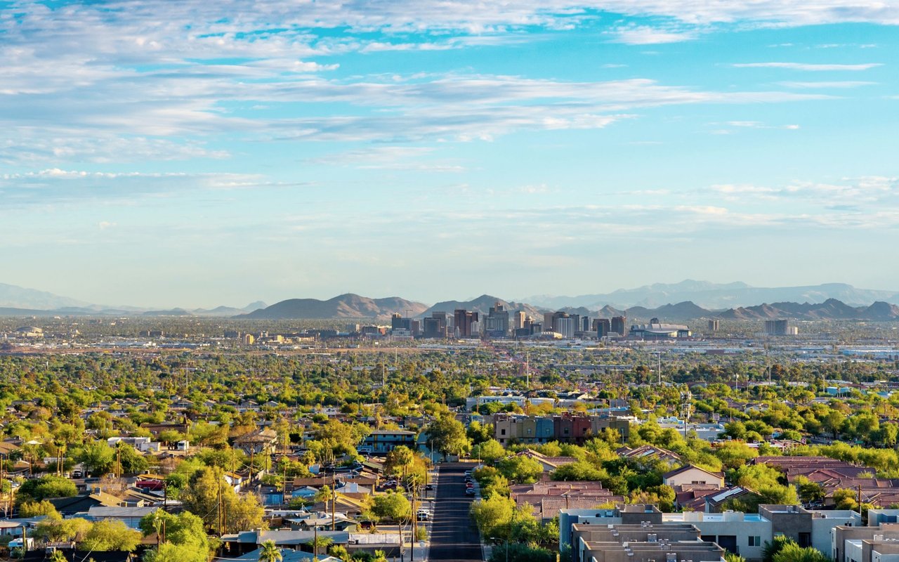Phoenix neighborhoods and downtown skyline with mountains in the distance.