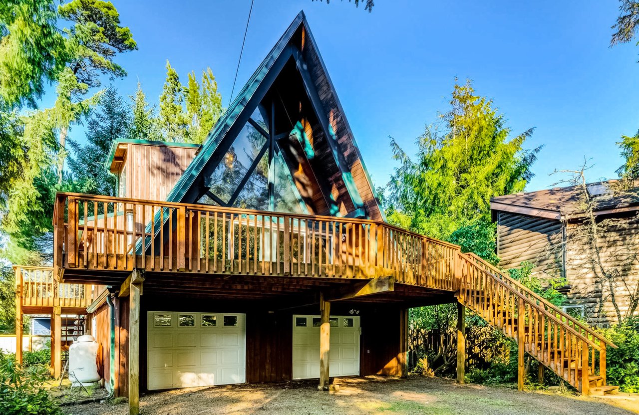 Sold A-frame home at 9190 Sitka Ln in Manzanita, Oregon, by Leisha Mizee-Riggert Home + Sea Realty, with a wooded setting and beach access nearby.