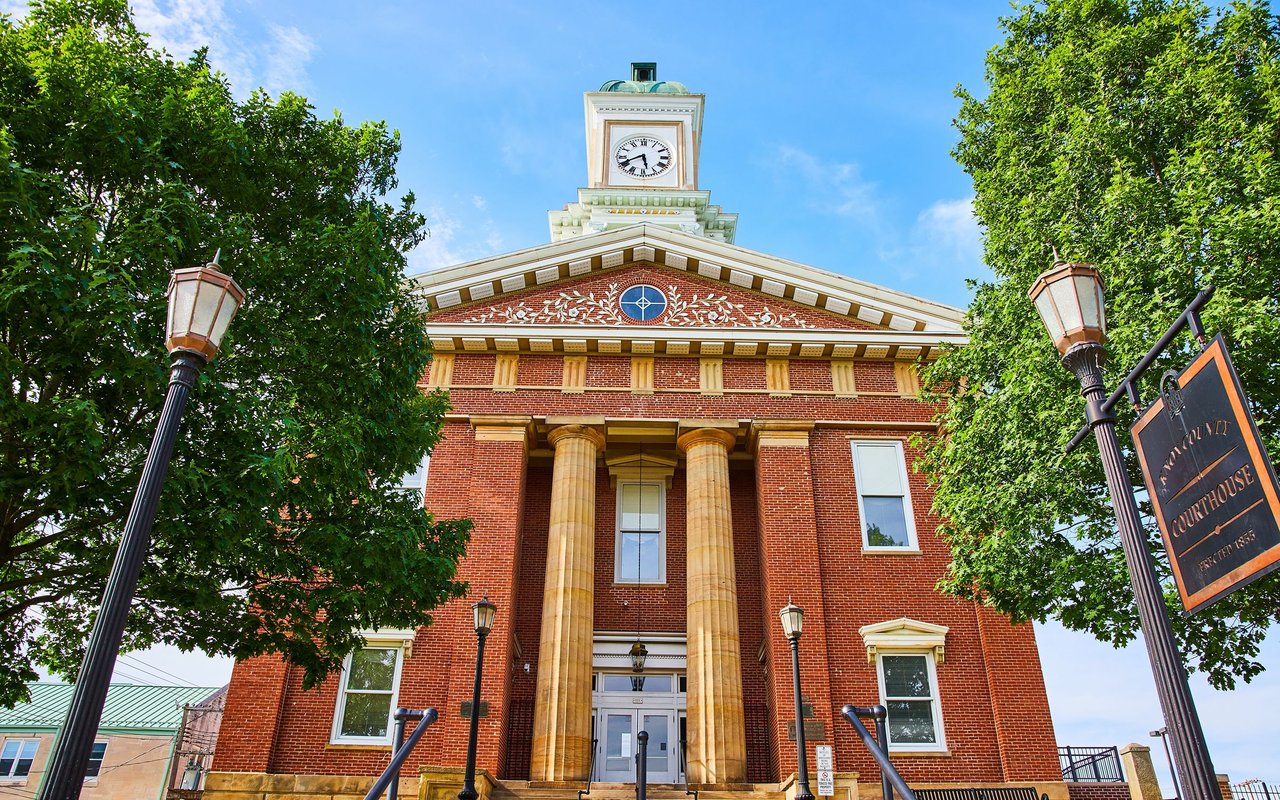 Montgomery County Courthouse with a red-brick façade, columns, and clock tower.