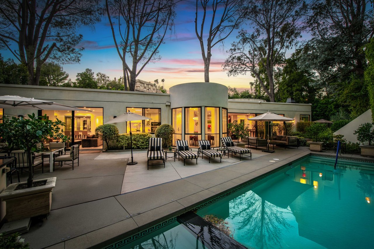 Modern luxury home at twilight with illuminated pool in Los Angeles 