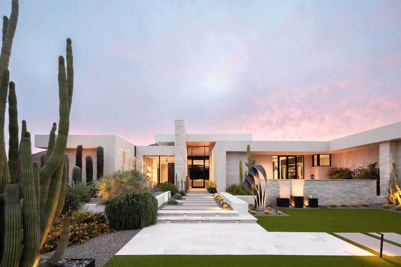 Modern luxury home in Paradise Valley with resort-style backyard, pool, fire feature, and contemporary architecture at sunset.