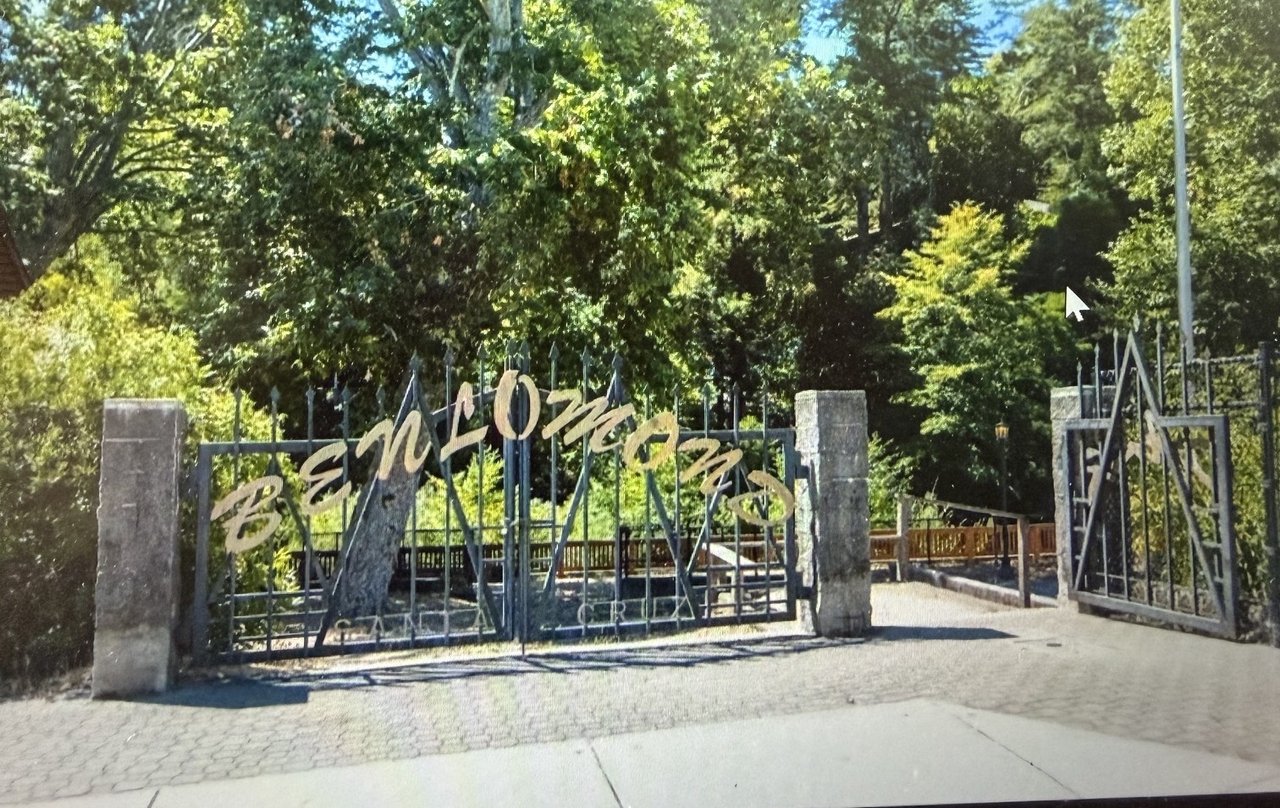 Ben Lomond park entrance with gold lettering on a metal gate beneath leafy trees.