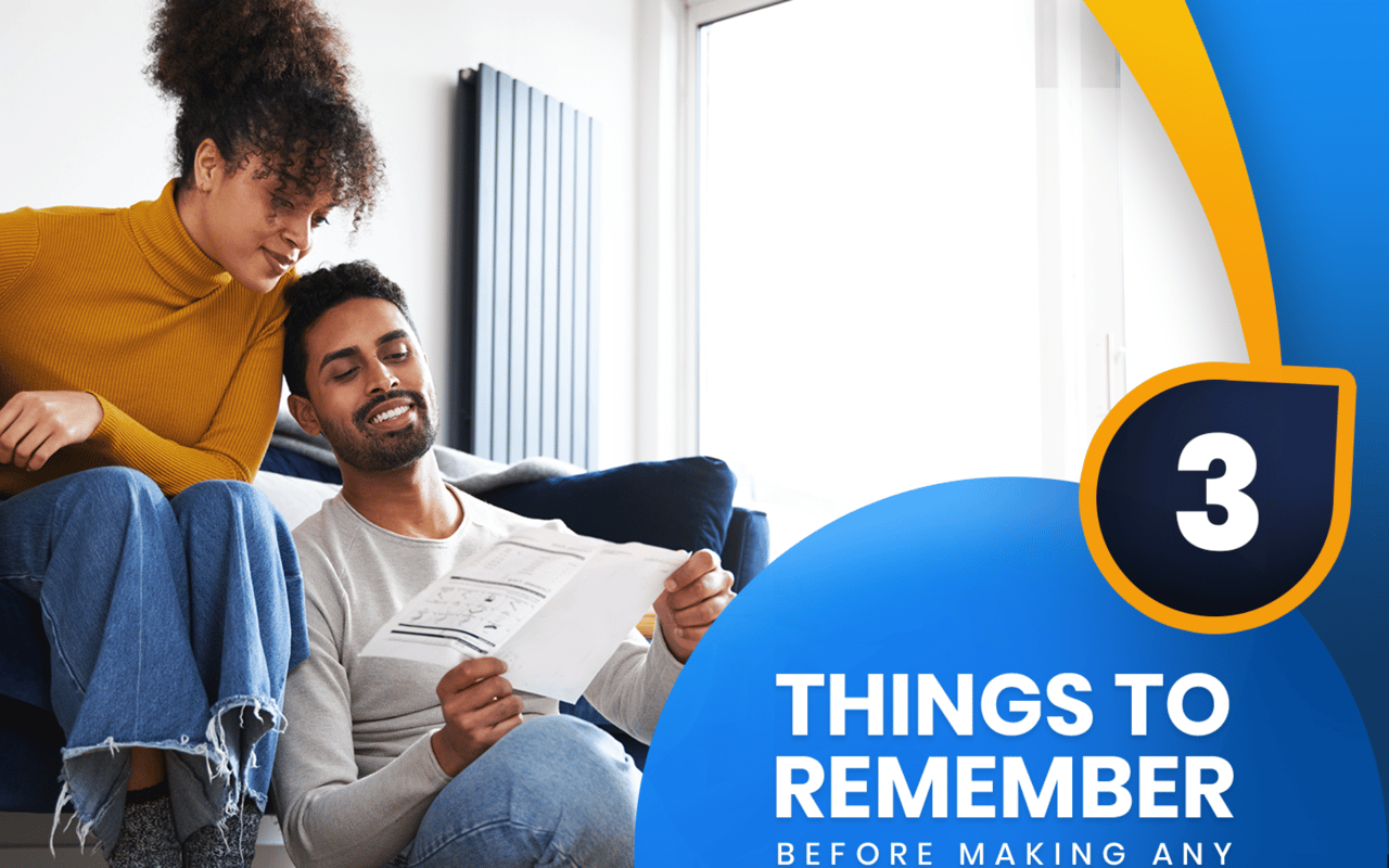 Three things to remember before making any updates when selling your home; a couple reviews paperwork on a sofa.