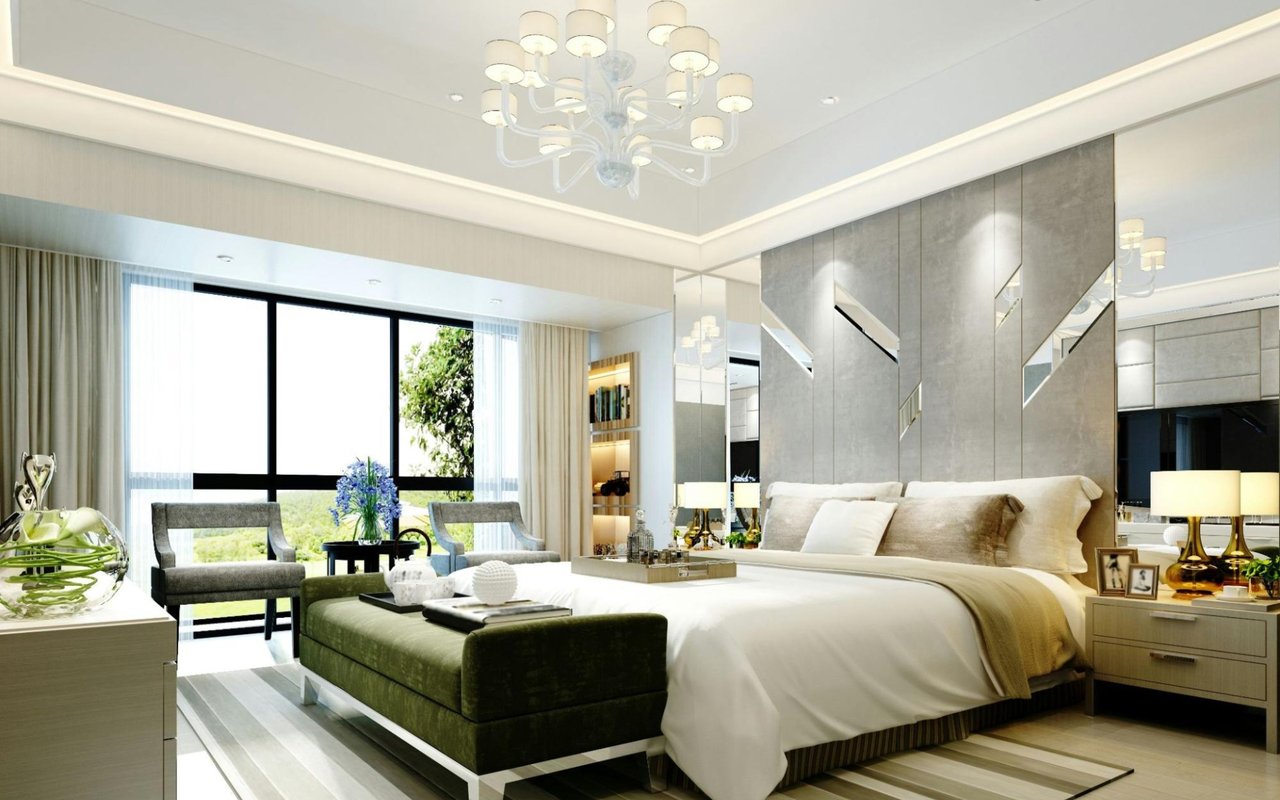 A spacious and luxurious modern bedroom with a large bed featuring white and beige bedding. 