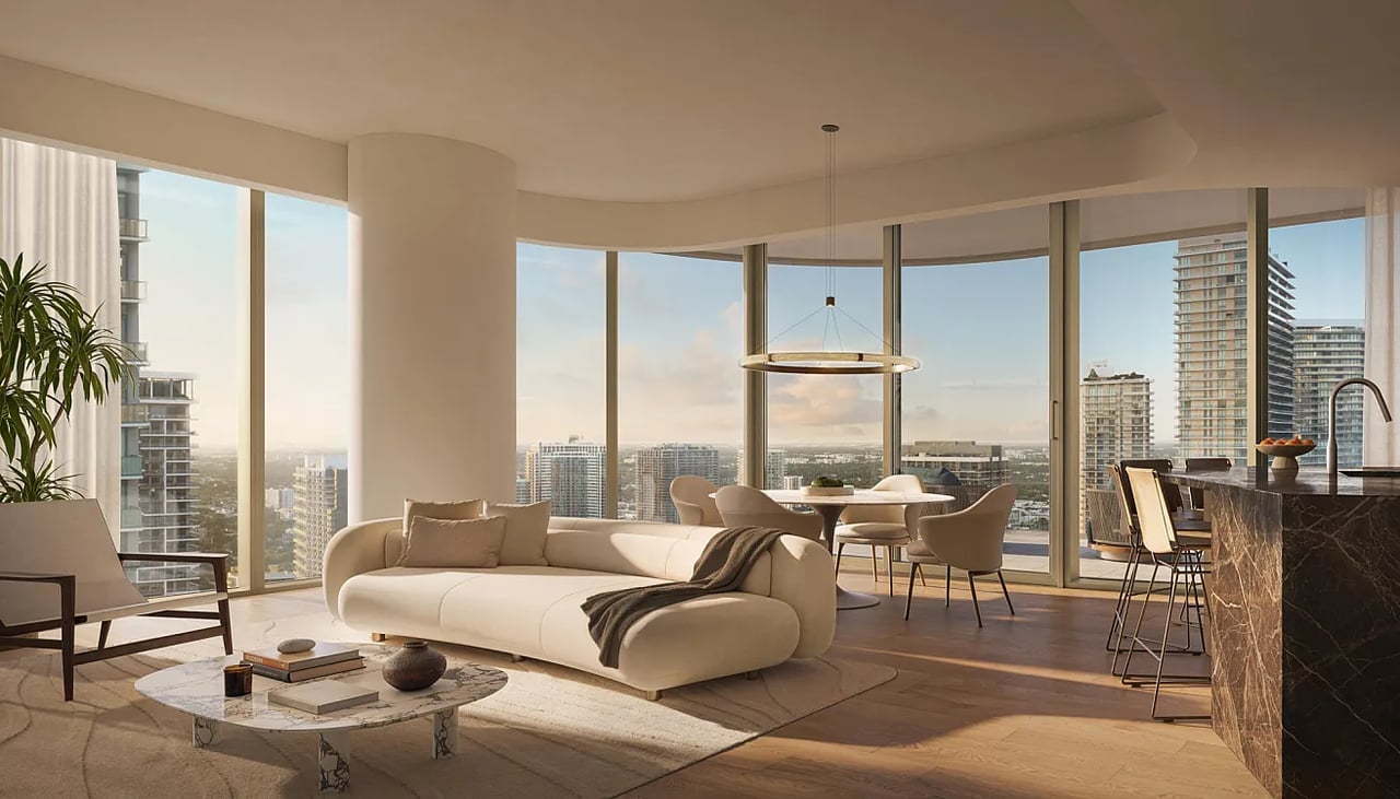 Staged high-rise living room with floor-to-ceiling windows overlooking a city skyline.