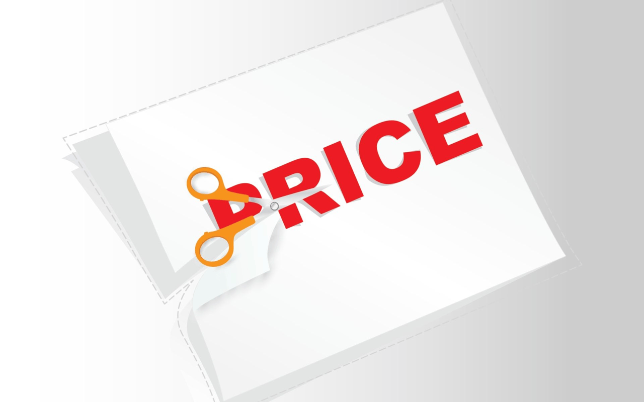 Orange scissors cut across the red word “PRICE” on a sheet of paper.