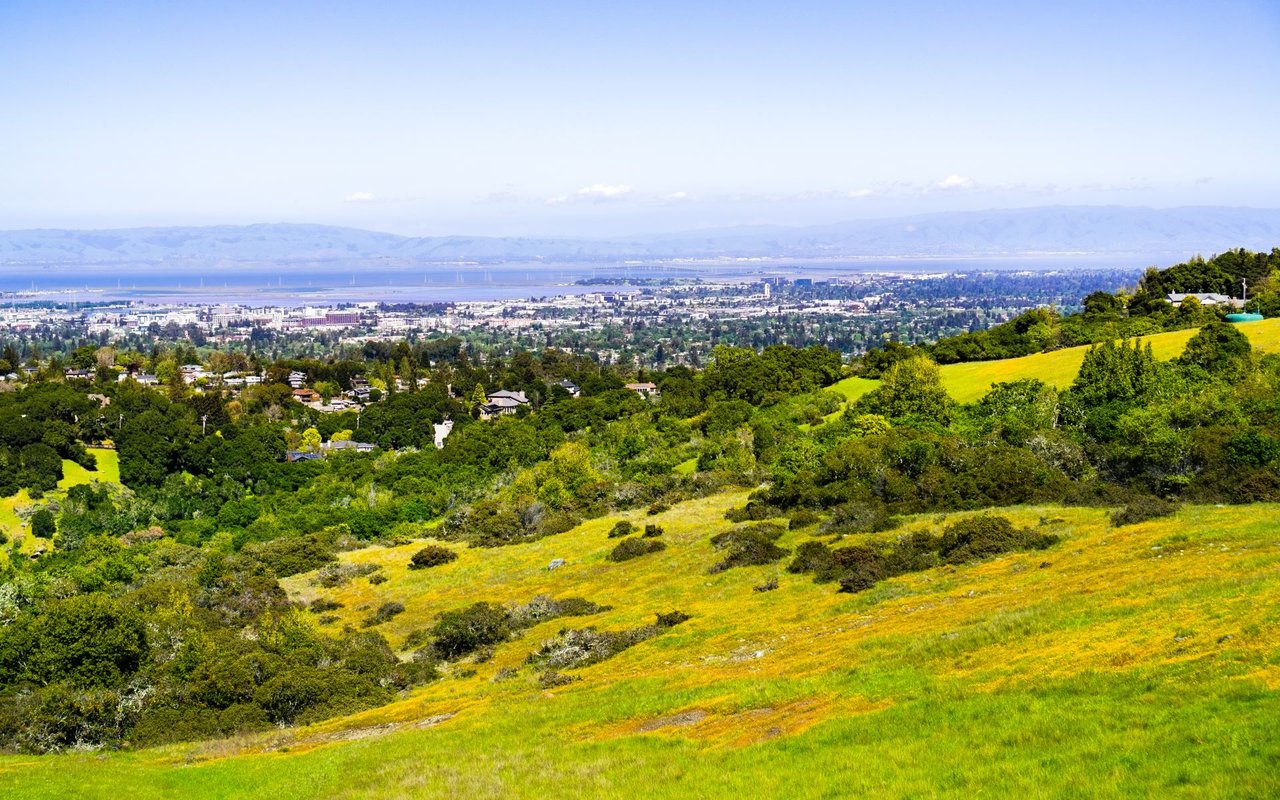 Scenic view of Menlo Park showing homes in a valley with mountain range in the background