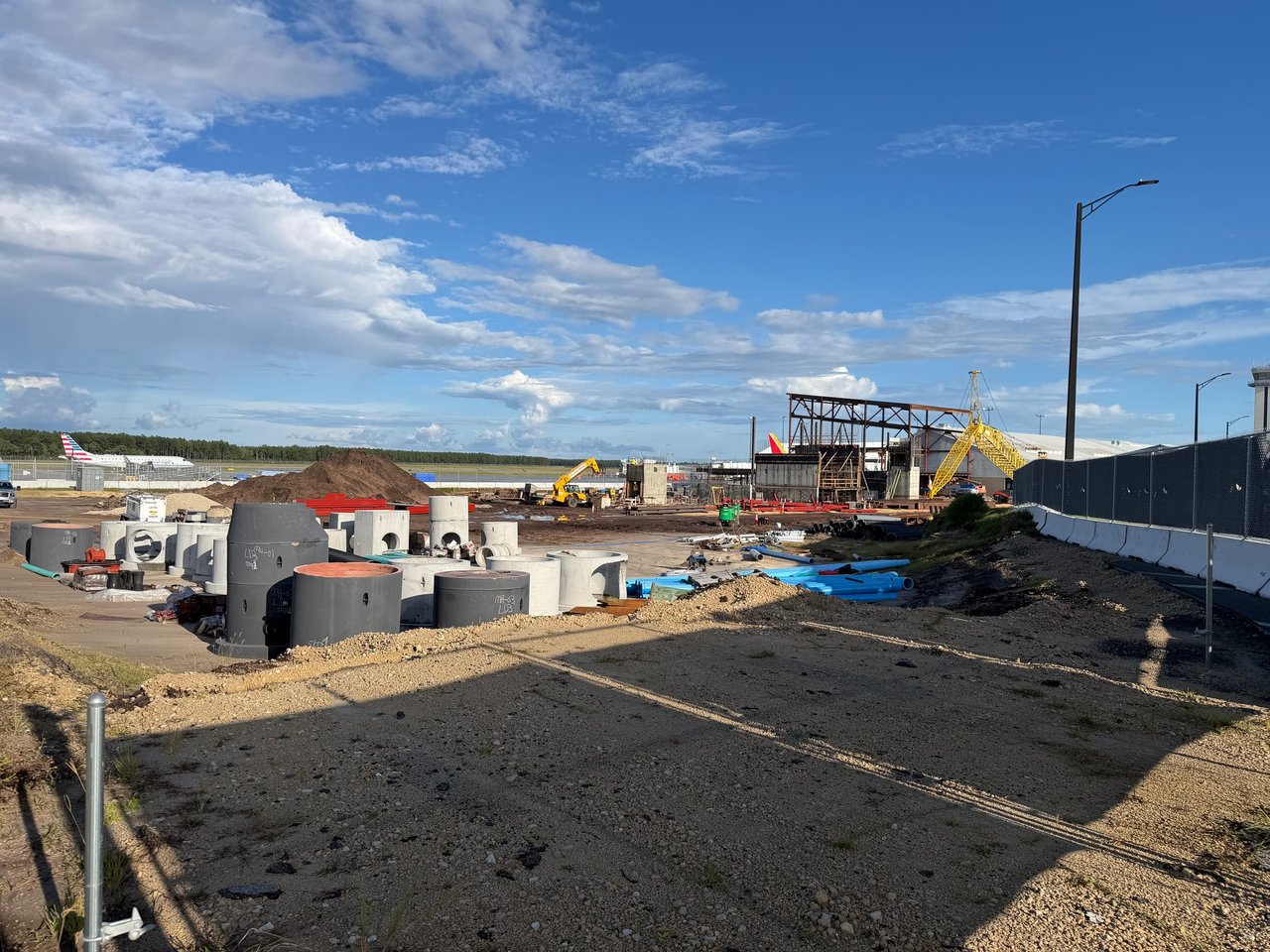 Steel framing rises for the new terminal expansion at the Panama City Beach airport as airliners wait at the gates nearby