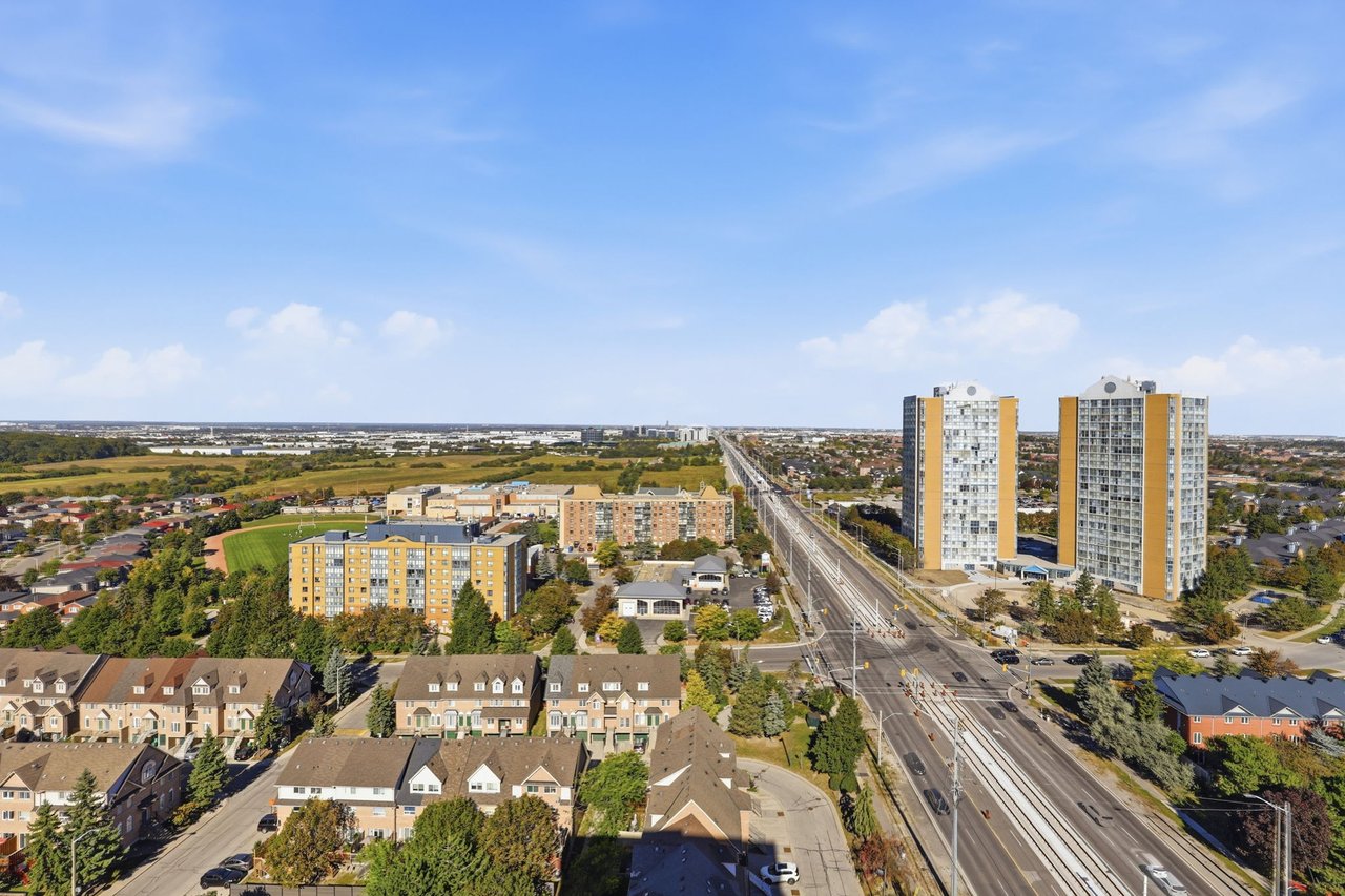Elevated view over Mississauga neighborhoods, apartment towers, and a major road.