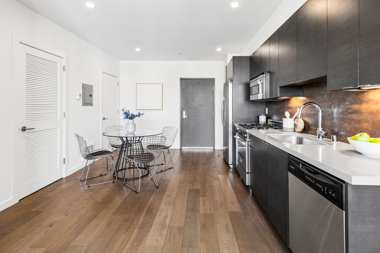 Modern kitchen featuring stainless steel appliances, gas range, quartz countertops, and custom cabinetry—designed for both culinary enthusiasts and effortless everyday living.