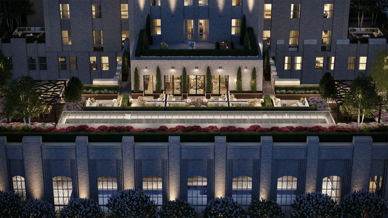 Waldorf Astoria Residences rooftop terrace with lounge seating and a glass-covered pool structure at night.