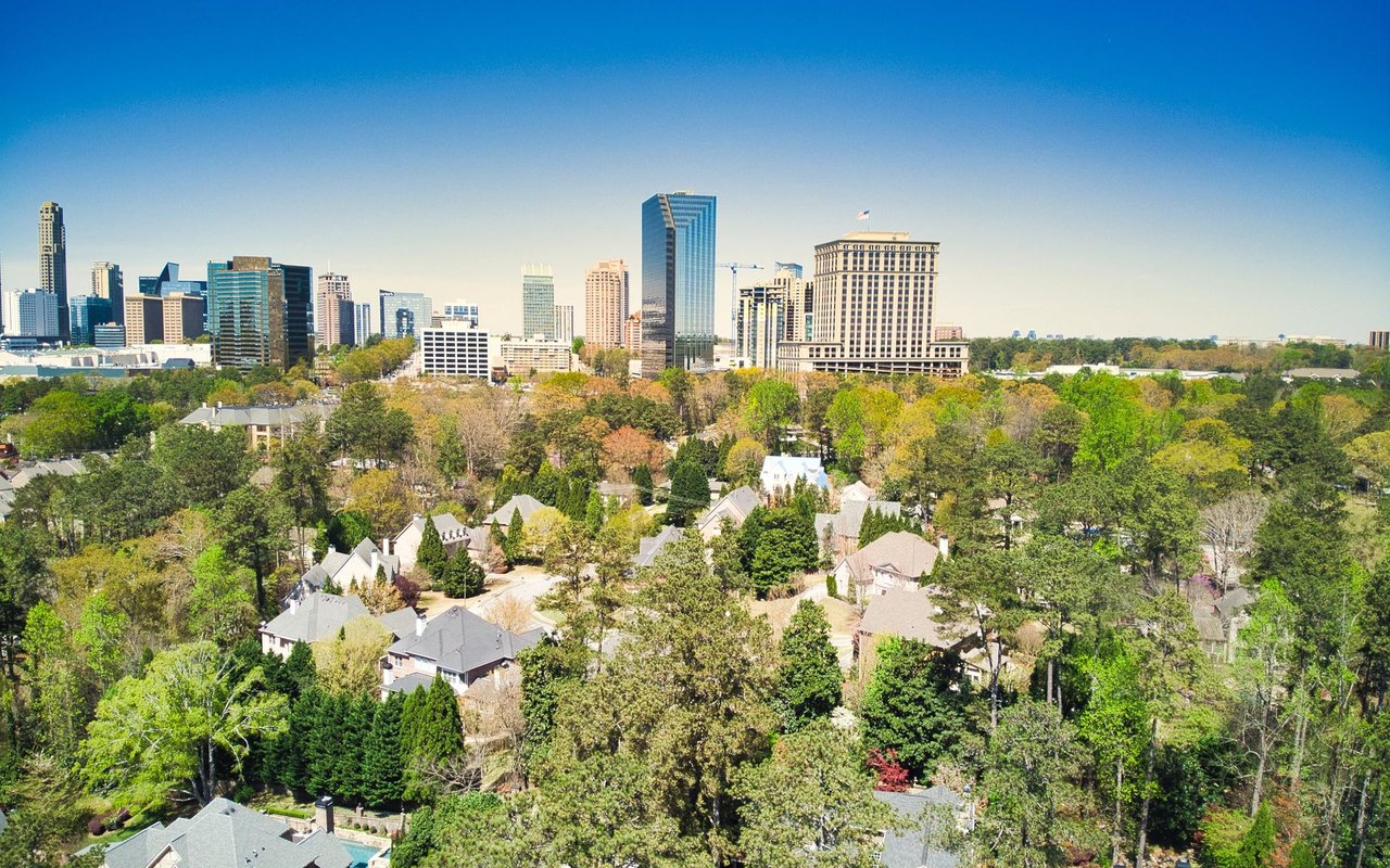 Buckhead neighborhood and Atlanta skyline beyond a leafy residential area.