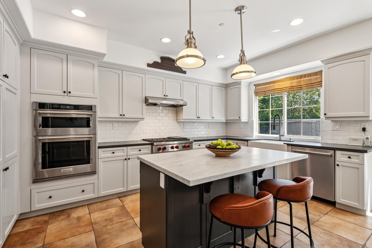 Sun-filled dining area with elegant design details and ample room for guests.