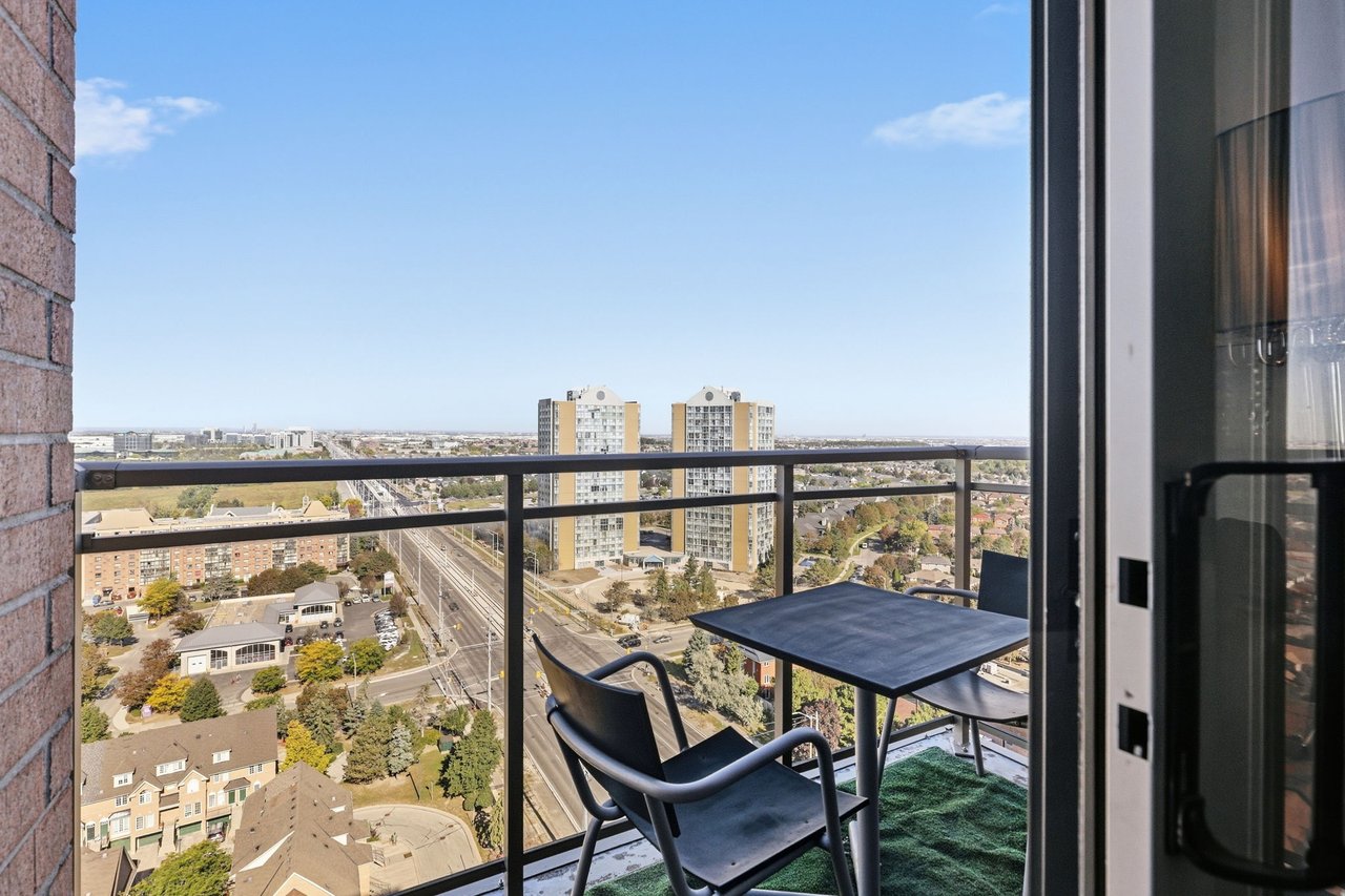 High-rise balcony with black table and chairs overlooking Mississauga homes and residential towers.