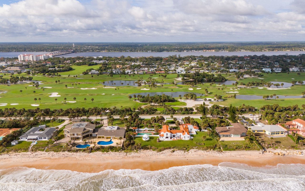 Aerial view of oceanfront homes, a golf course, and waterways in Ormond Beach, Florida