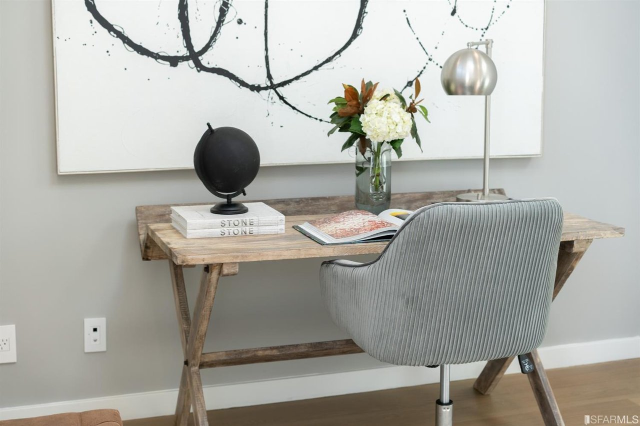 Home workspace with desk, chair, and decorative wall art