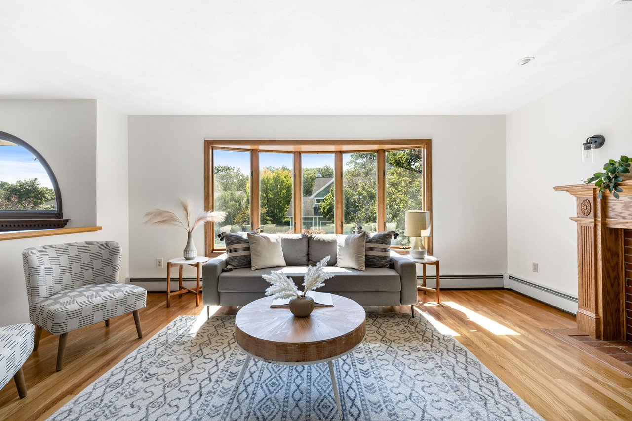 Living room with sunlit bay window