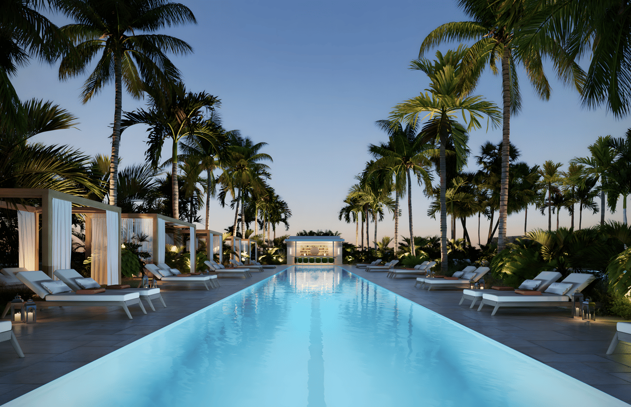 Outdoor pool lined with cabanas and loungers beneath tall palm trees.