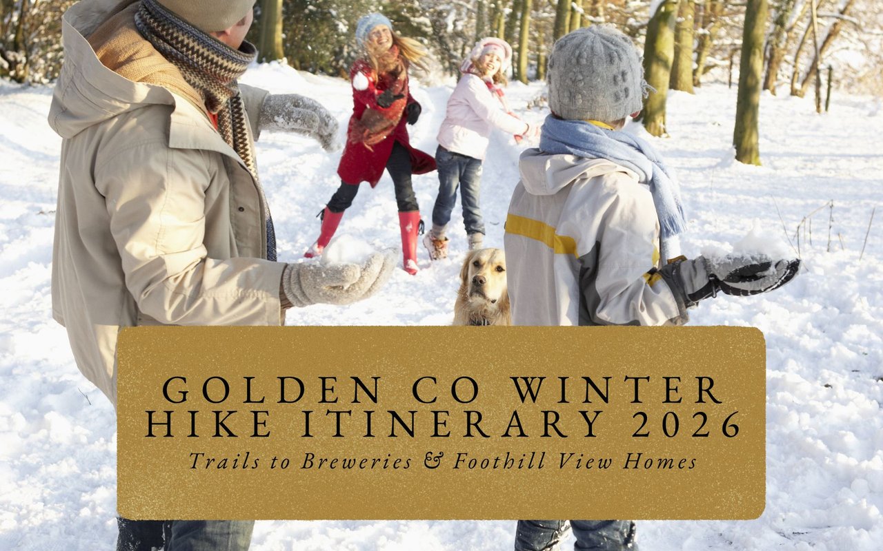 Family of hikers enjoying snowy overlook with distant Denver skyline and snow-capped Rocky Mountains at Lookout Mountain.