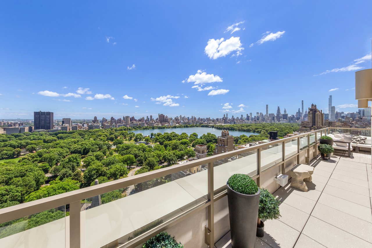 Private terrace overlooking Central Park, the Jacqueline Kennedy Onassis Reservoir, and the Manhattan skyline on a clear summer day