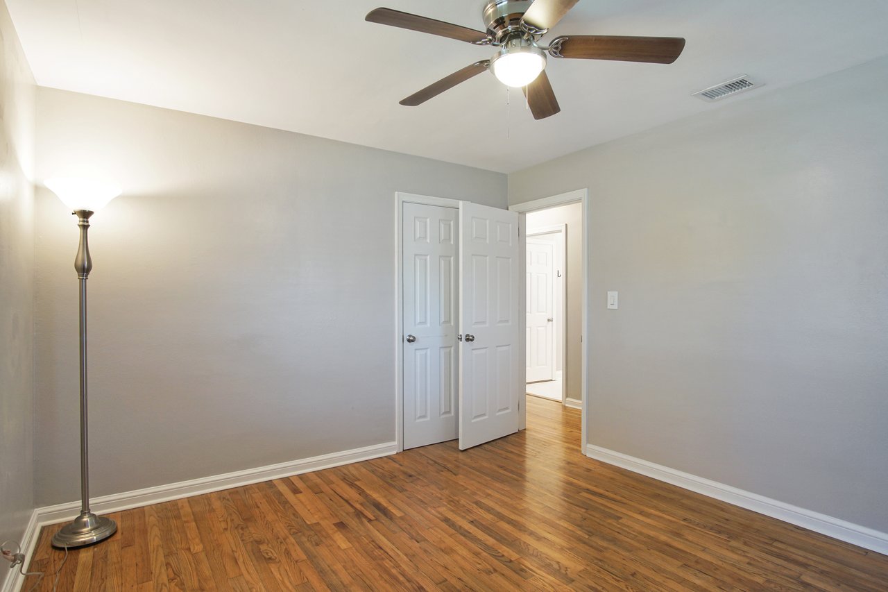 A cozy room featuring hardwood floors and a ceiling fan, creating a warm and inviting atmosphere.