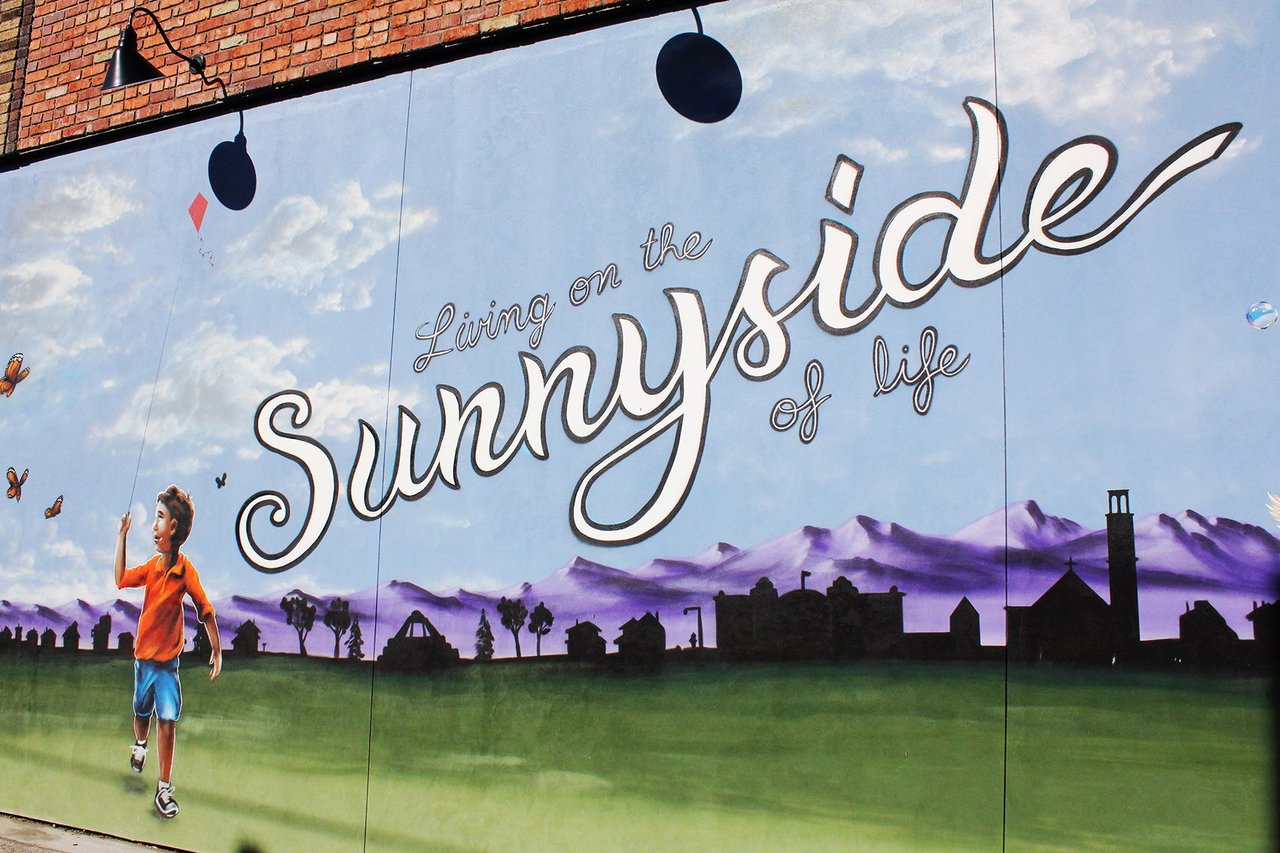 Mural on the exterior wall at 35 Sunnyside in Denver, featuring colorful street art on a residential property.