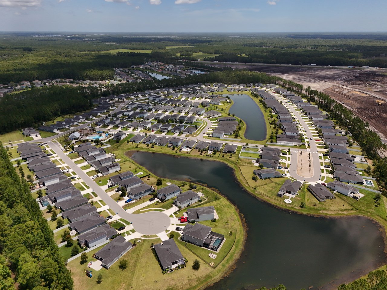 Aerial view of Meadow Ridge homes and streets surrounding two ponds.
