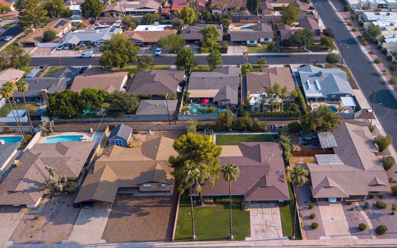 Aerial view of Condado homes, residential streets, and backyard swimming pools.