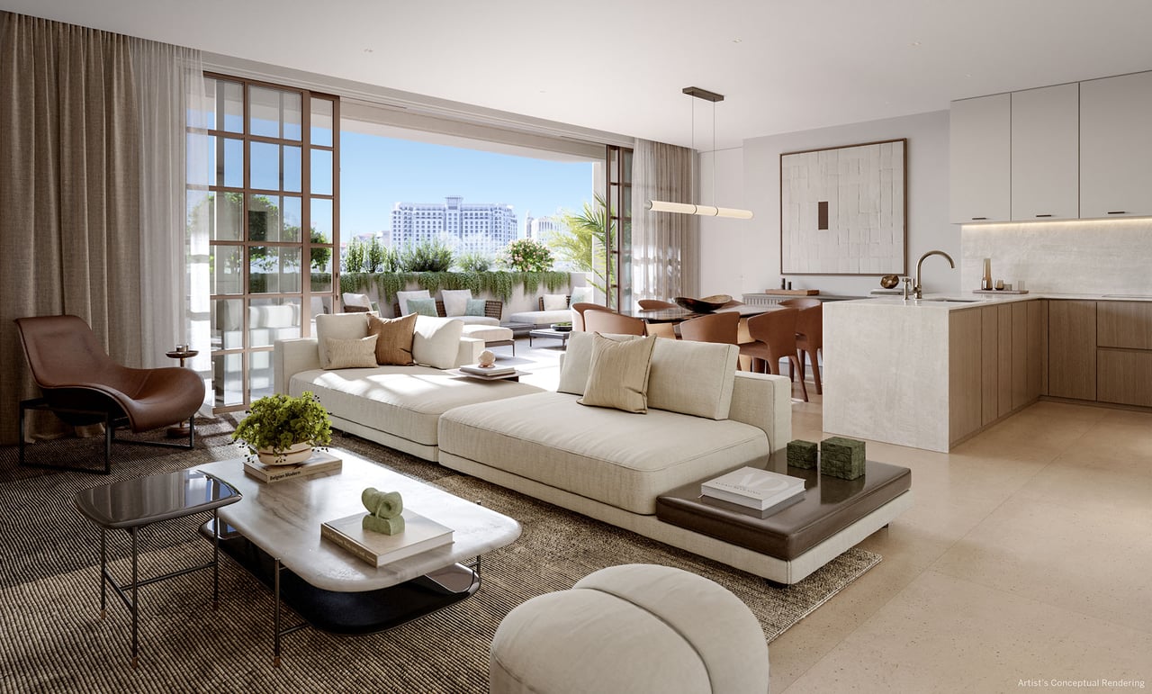 Open-plan residence living room with cream sectional, contemporary kitchen and doors to a planted terrace.