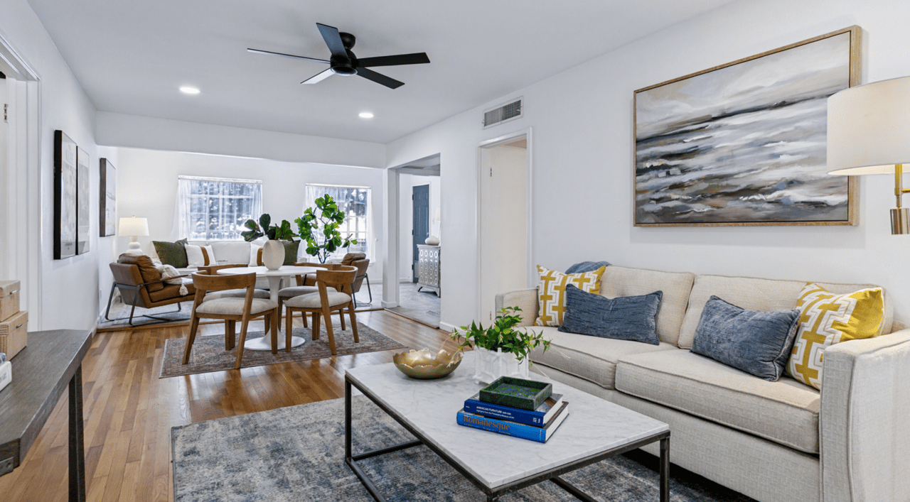 707 Sumner Dr in San Antonio, featuring original hardwood floors, fresh white walls, large windows, and abundant natural light.
