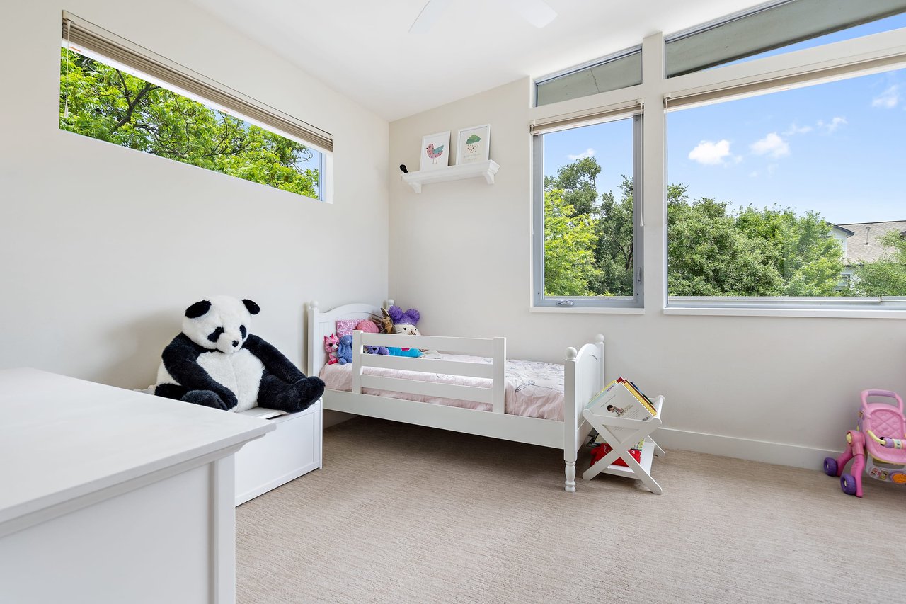 Children's bedroom with a bunk bed and large windows at 34 Margranita Crescent, Tarrytown, Austin, TX.