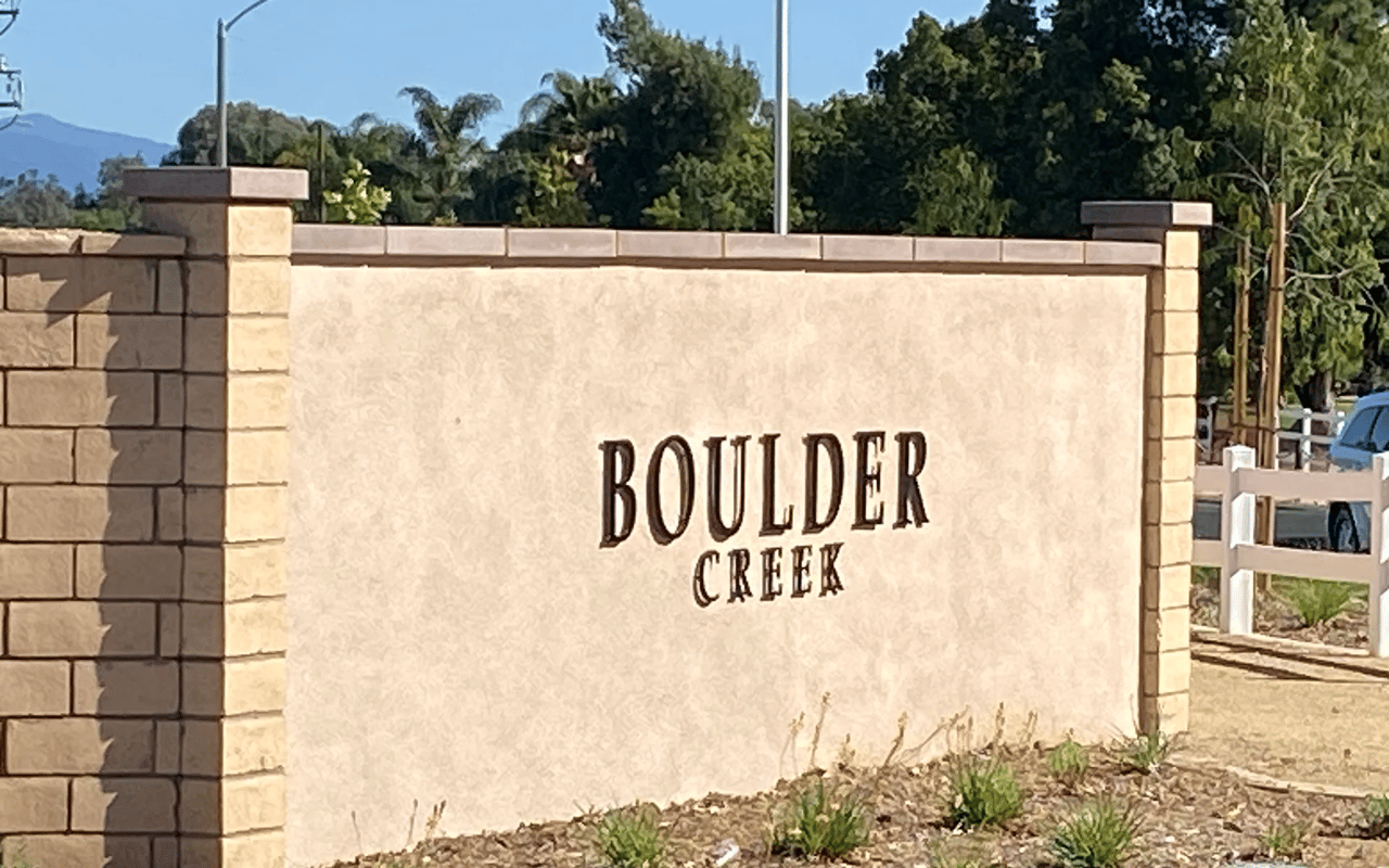 The landscaped monument sign at the entrance to the Boulder Creek neighborhood in Wildomar, CA.