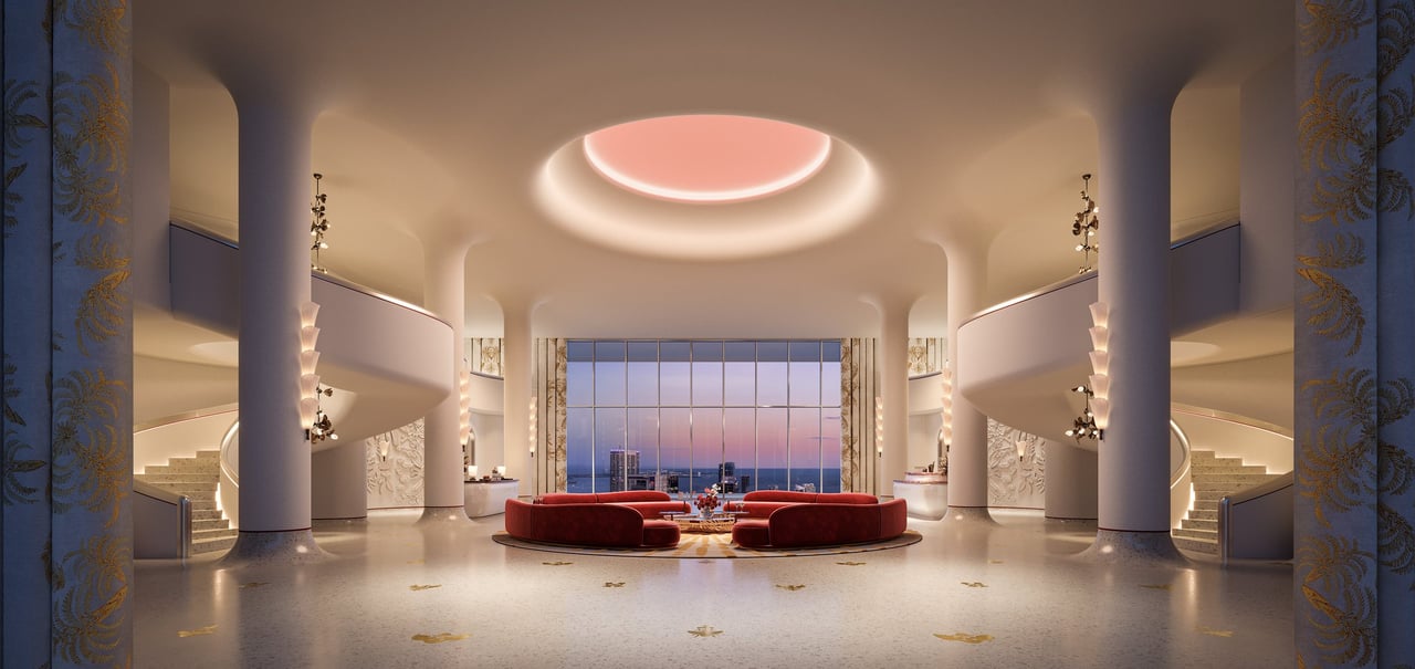 Faena Residences Miami lobby with red seating and a dusk ocean and skyline view.