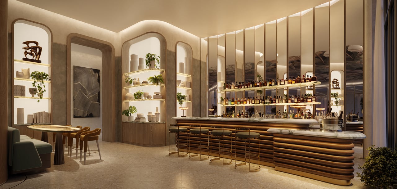 Bar and lounge with a curved wood-fronted bar, brass-framed mirrors, and bottle shelves.