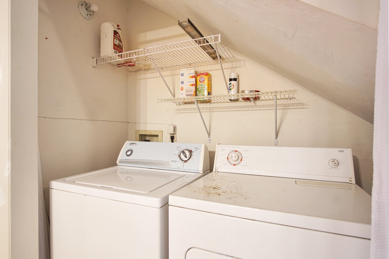 A white washer and dryer set, showcasing a modern design in a clean laundry room environment.