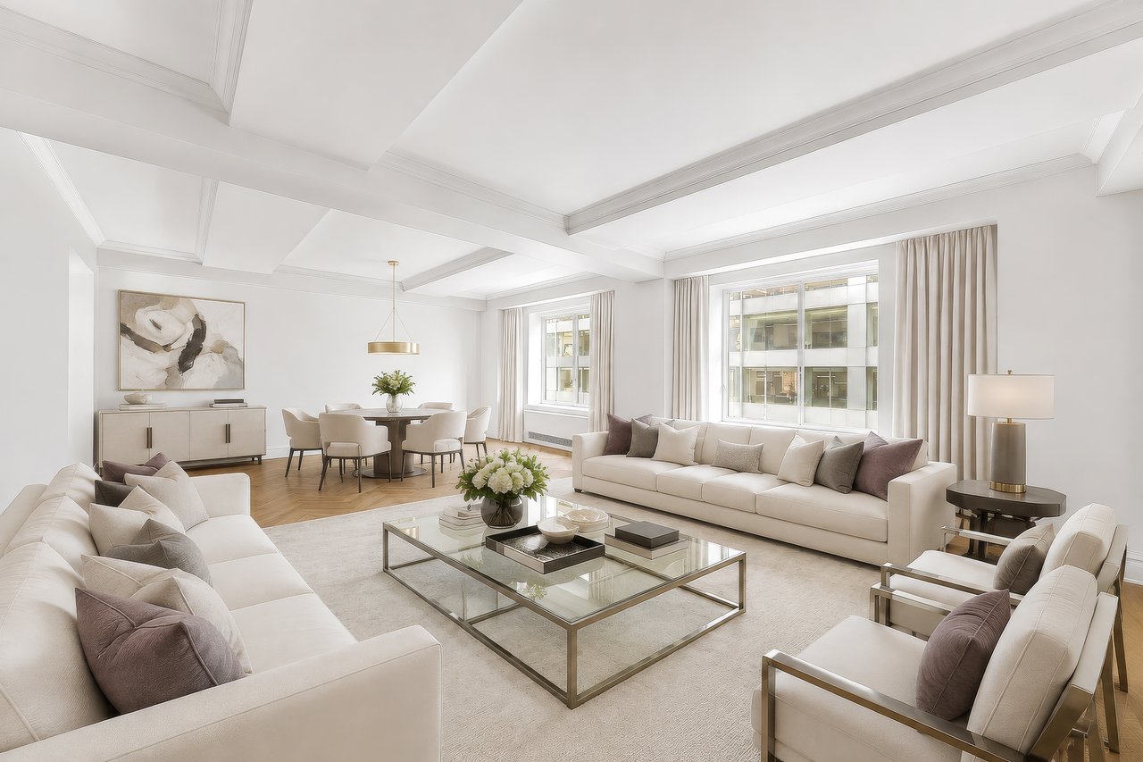 Staged living room with cream seating, a glass coffee table, and coffered ceiling.