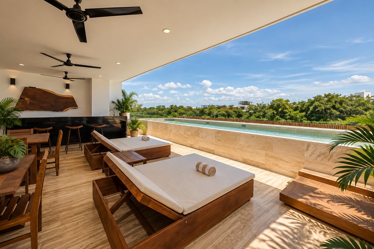 Condo rooftop terrace with a narrow pool, cushioned loungers, dining area, and treetop views.
