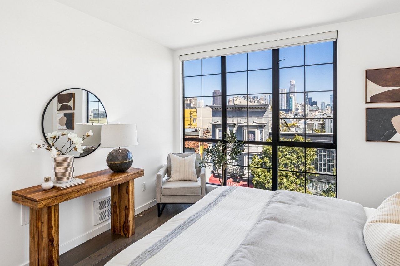 Spacious bedroom with designer touches, generous light, and picturesque outlooks, offering comfort and tranquility above the vibrant city below.