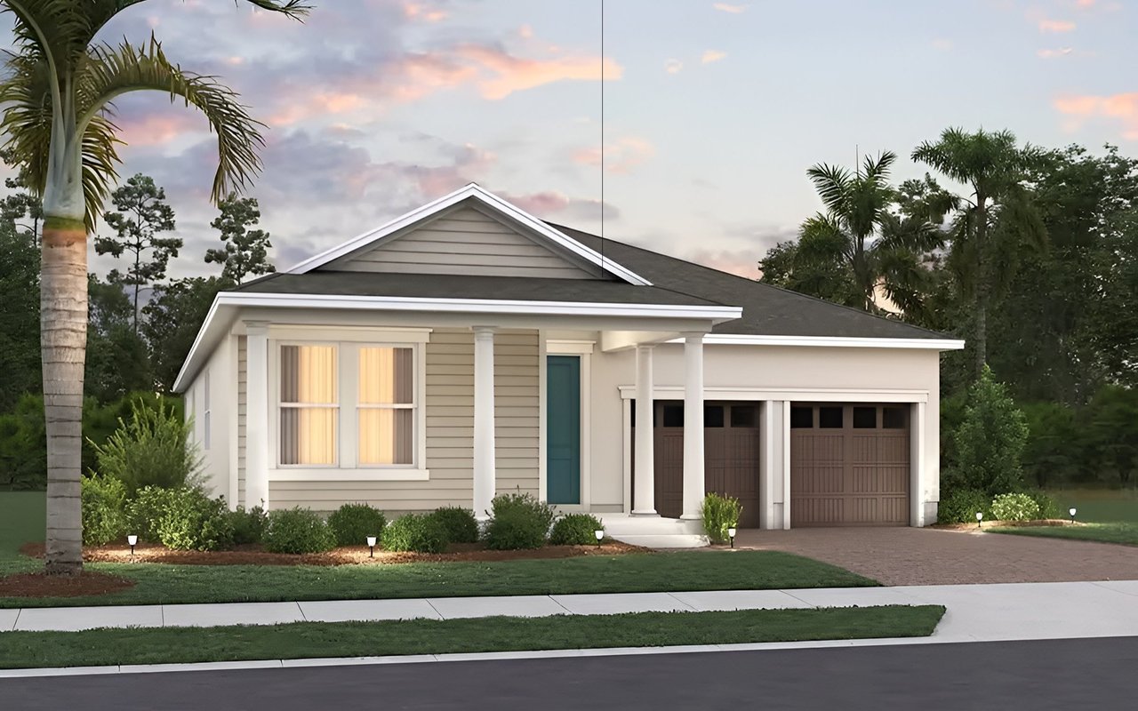 Single-story home with a covered entry, two-car garage, and palm trees at sunset.