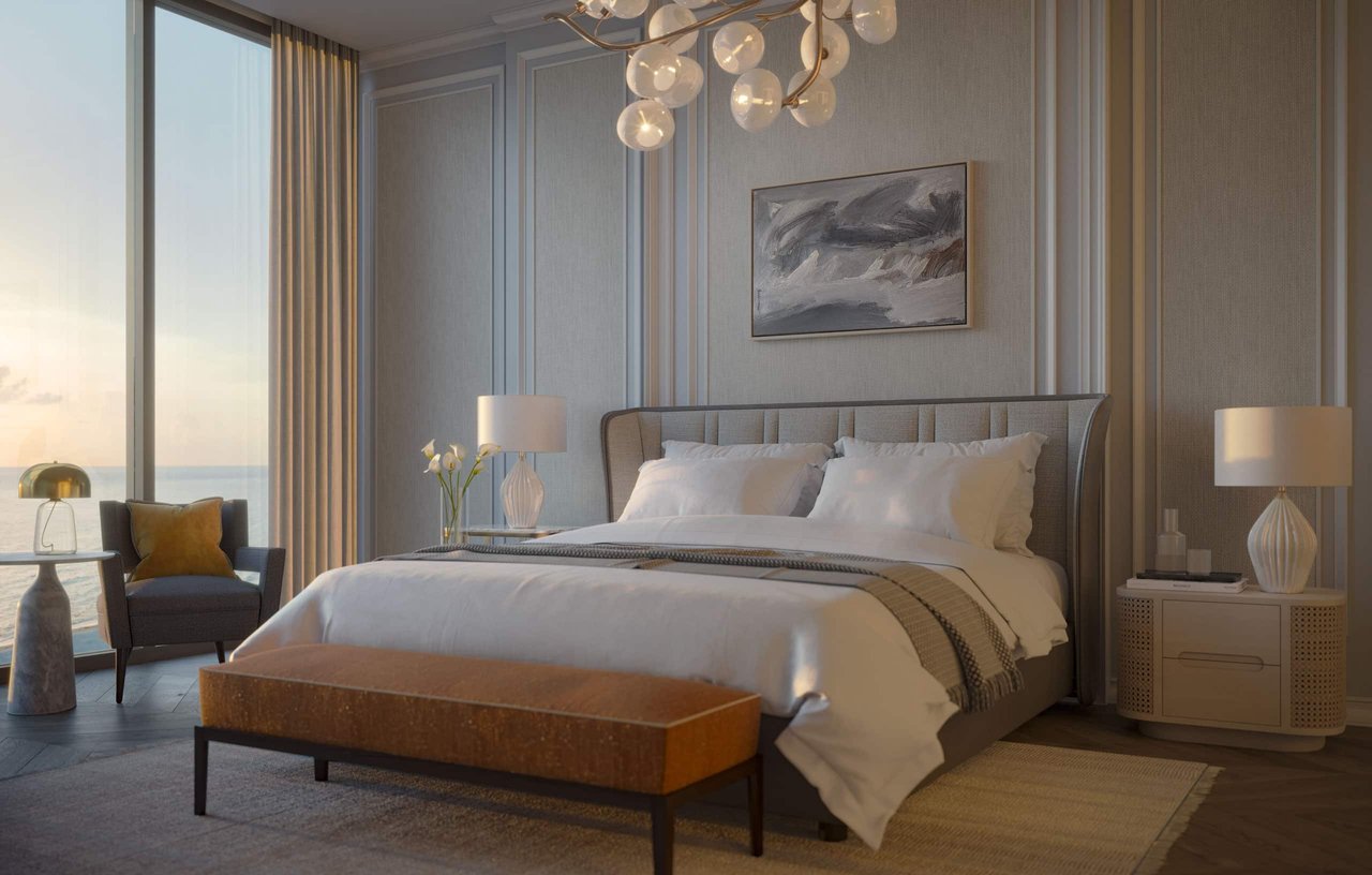 Furnished bedroom with a king bed and floor-to-ceiling windows overlooking the water.