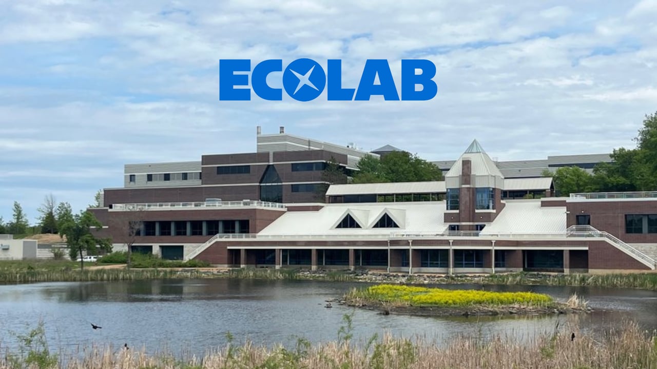 Ecolab campus building beside a pond, with the ECOLAB logo above.