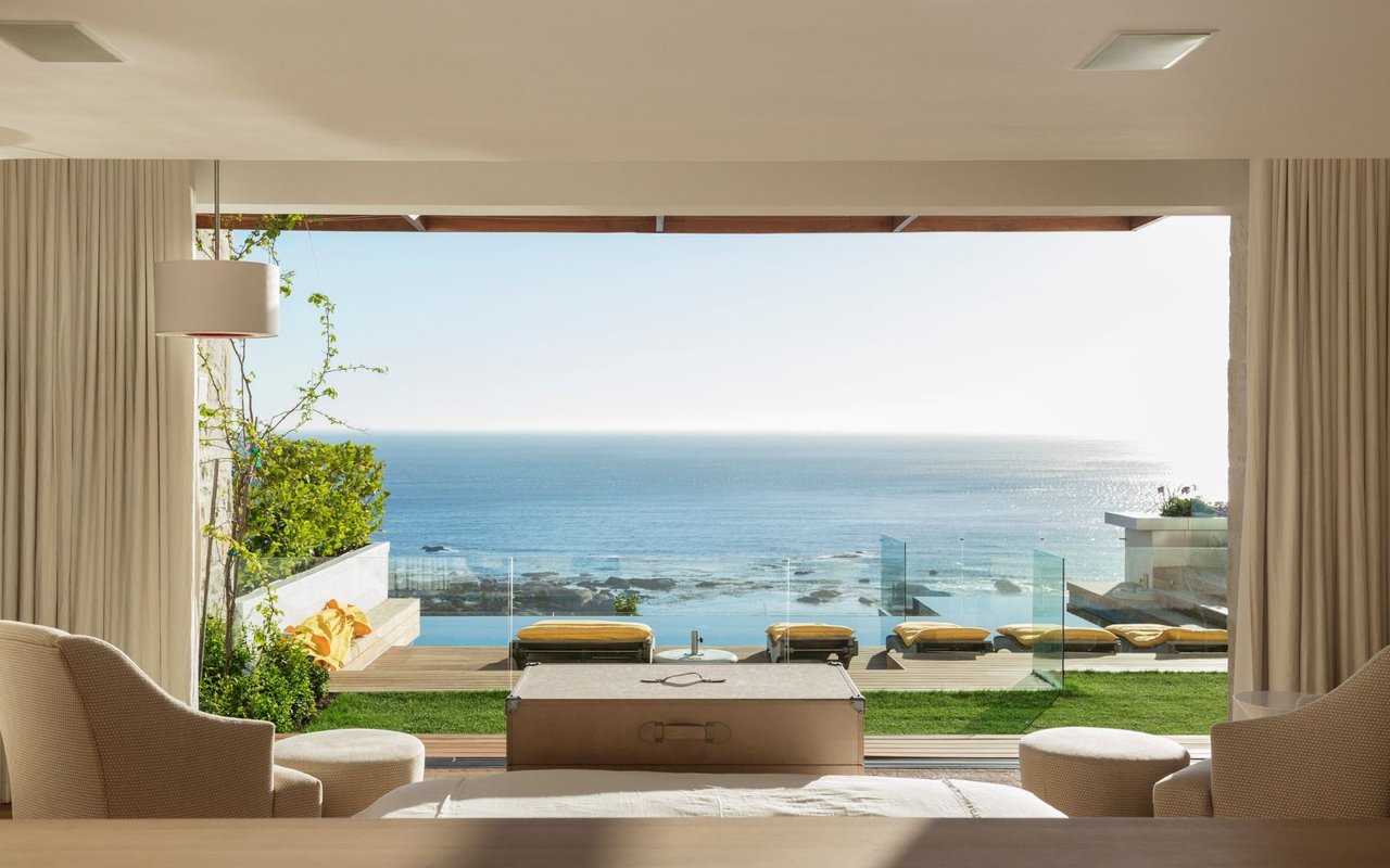 Sunny bedroom and patio overlooking ocean